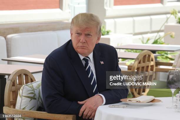 President Donald Trump sits to lunch with the French President at the Hotel du Palais in Biarritz, south-west France on August 24 on the first day of...