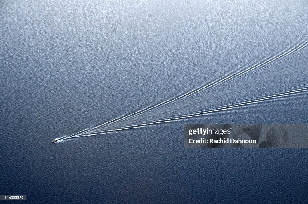 An aerial view of a boat leaving ripples in Lake Tahoe creating an abstract pattern, CA.