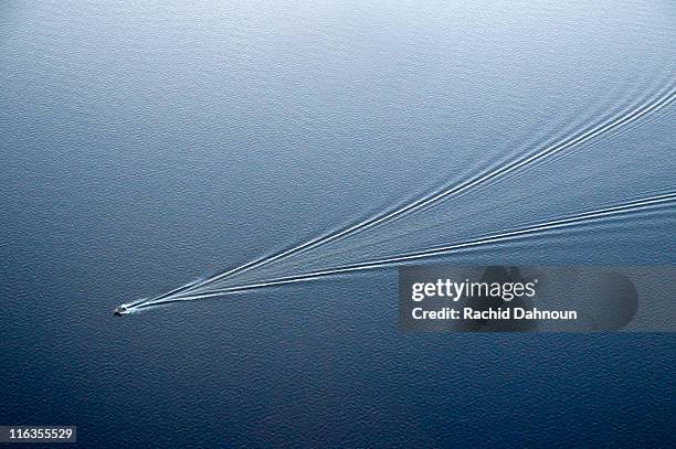 an aerial view of a boat leaving ripples in lake tahoe creating an abstract pattern, ca. - boat wake stock pictures, royalty-free photos & images