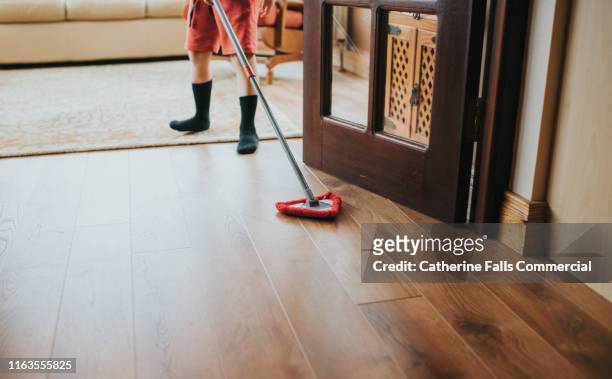 brushing the floor - sweeping floor stock pictures, royalty-free photos & images