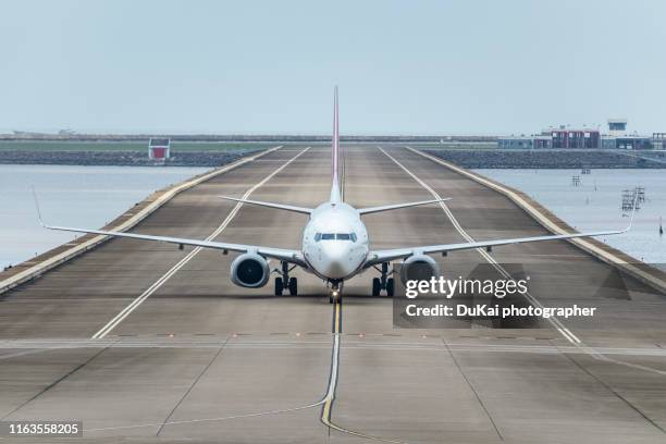 macau international airport - landing touching down stock pictures, royalty-free photos & images