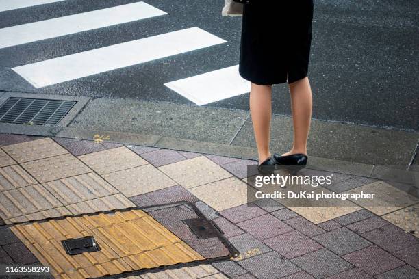 woman wearing high heels while standing on street in tokyo - stockings feet 個照片及圖片檔