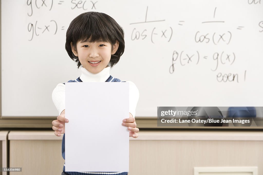 Confident student standing in front of math work