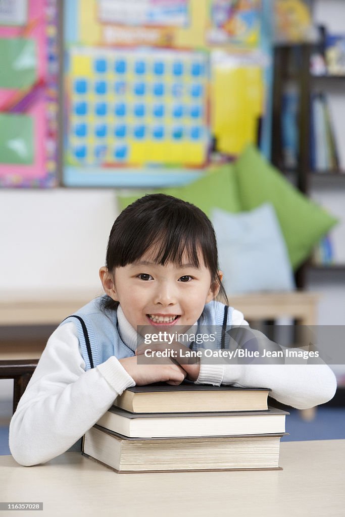 Students Using Books Young Student Holding Books In Classroom High-Res Stock Photo - Getty ...