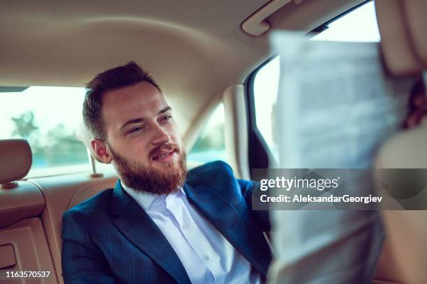 newspaper in car to start the day - man in car reading newspaper stock pictures, royalty-free photos & images