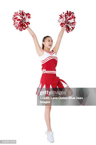 cheerleader in action with her pom-poms - asian cheerleaders ストックフォトと画像
