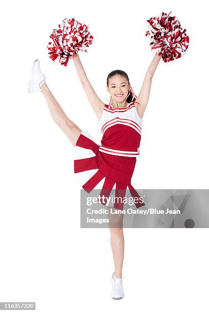 cheerleader in action with her pom-poms - cheerleader white background stock pictures, royalty-free photos & images