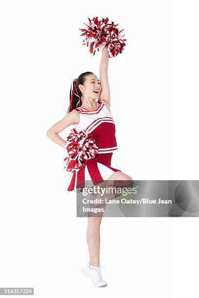 cheerleader in action with her pom-poms - asian cheerleaders stock-fotos und bilder