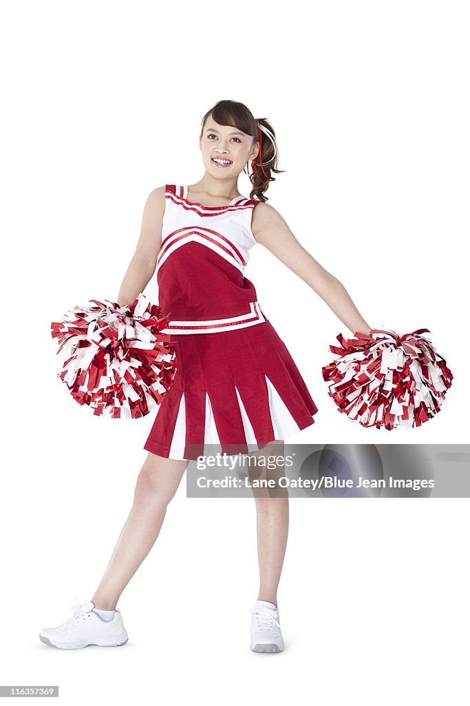 Cheerleader in action with her pom-poms