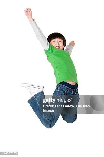 young boy jumping up with excitement - kids side view isolated stockfoto's en -beelden