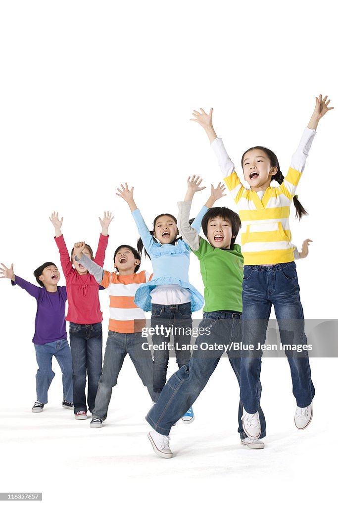 A group of children jumping up with excitement