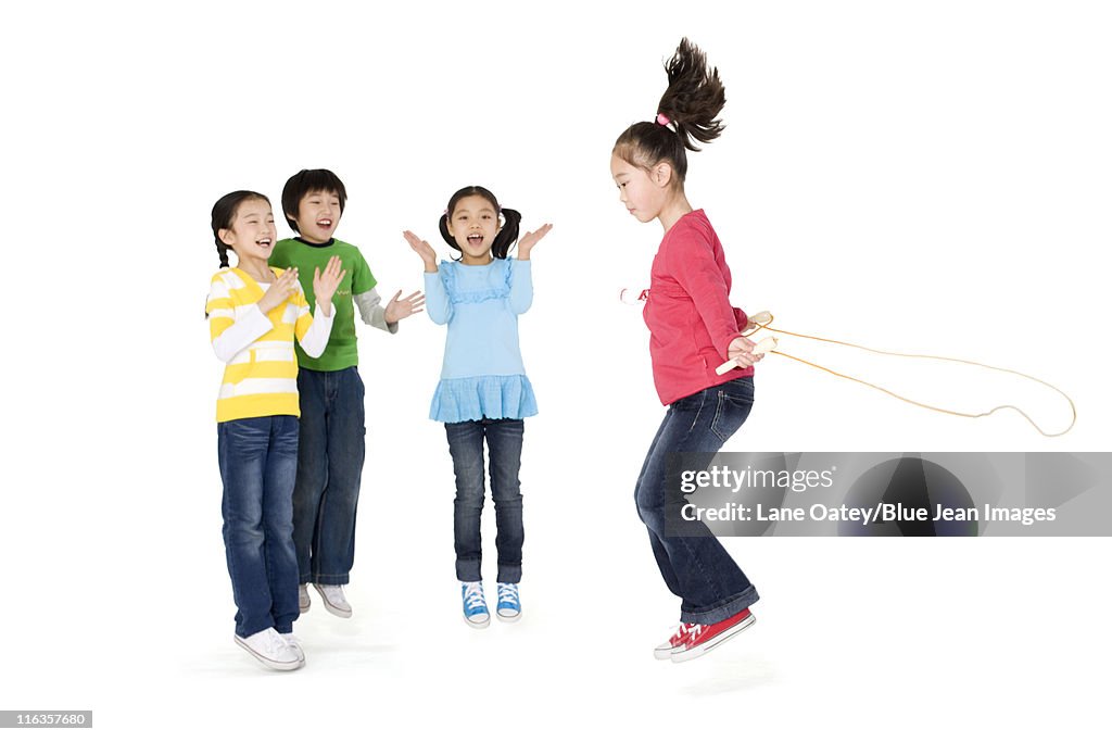 Friends Cheering Their Friend As She Jump Ropes High-Res Stock Photo ...