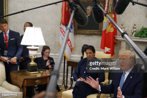 President Donald Trump and Prime Minister of the Islamic Republic of Pakistan, Imran Khan, speak to the media during a meeting in the Oval Office at...