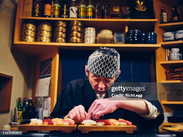 japanese sushi chef in a sushi shop - sushi bar stock pictures, royalty-free photos & images