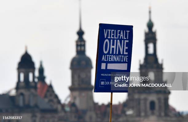 Protester carries a poster reading "Diversity without alternative" during a demonstration titled "Unteilbar" against exclusion on August 24, 2019 in...