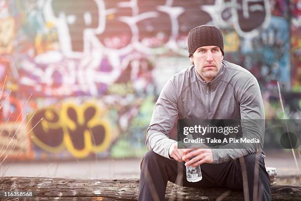 usa, washington, seattle, man in workout wear in front of graffiti wall -  "suprijono suharjoto" or "take a pix media" stock pictures, royalty-free photos & images