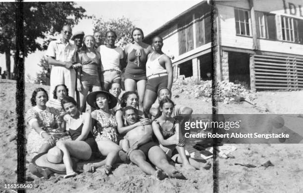 Portrait of a large group of unidentified people as they pose on the beach outside the Idlewild Club House, Idlewild, Michigan, September 1938....
