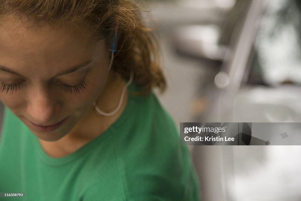 USA, New York City, Mid adult woman listening to music