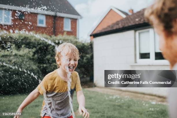 summer hose fun - wet hose ストックフォトと画像