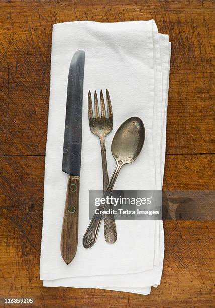 close up of silver forks, knife and spoon on napkin - knife and fork low angle stock pictures, royalty-free photos & images