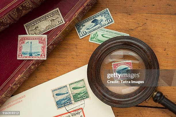 close up of stamps collection and magnifying glass - stamp collecting stock pictures, royalty-free photos & images