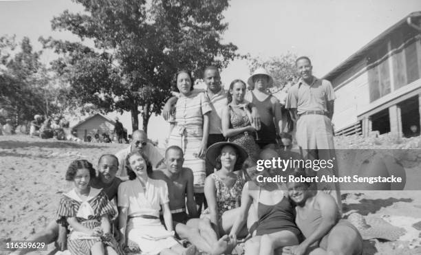 Portrait of a large group of unidentified people as they pose on the beach outside the Idlewild Club House, Idlewild, Michigan, September 1938....