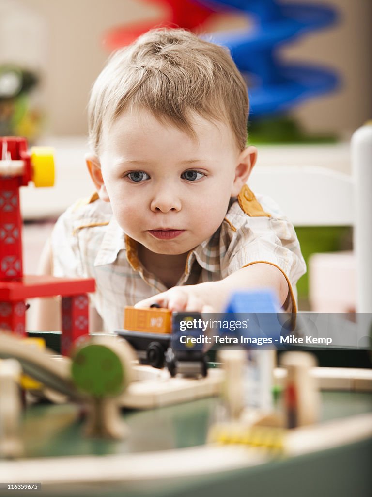 USA, Utah, Lehi, Boy (2-3) playing with toy train