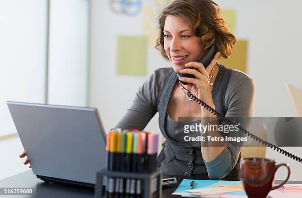 usa, new jersey, jersey city, woman working in home office - landline phone home stock pictures, royalty-free photos & images