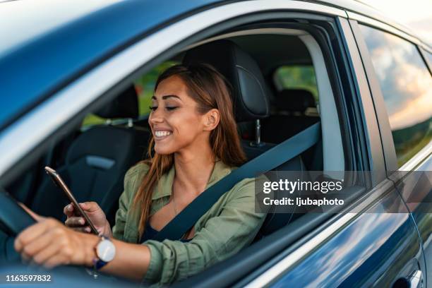 using smartphone while driving - mobile phone in hand driving stock pictures, royalty-free photos & images