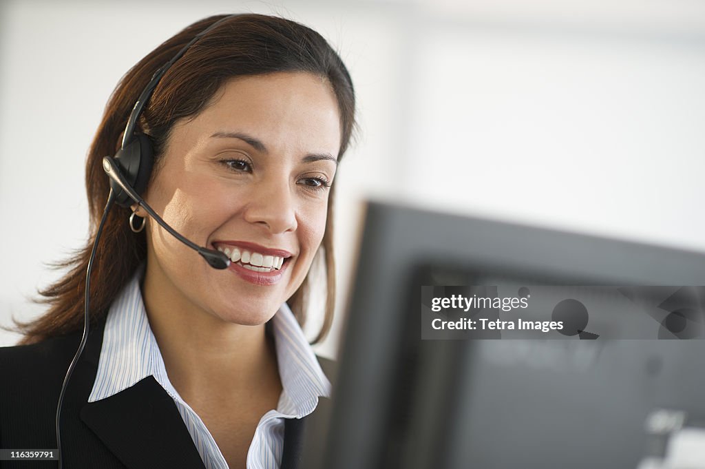 USA, New Jersey, Jersey City, smiling female customer service representative with headset