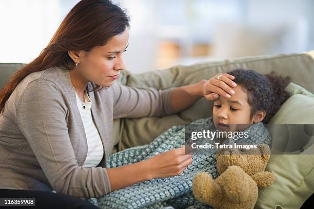 usa, new jersey, jersey city, mother taking daughter's (6-7) temperature - sick child stockfoto's en -beelden