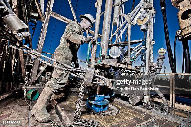 canada, alberta, oil workers using oil drill - oil worker stock pictures, royalty-free photos & images