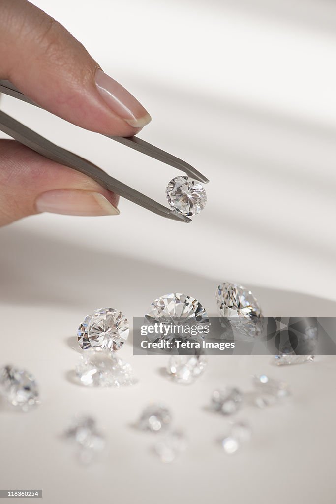 Studio shot of woman holding diamonds