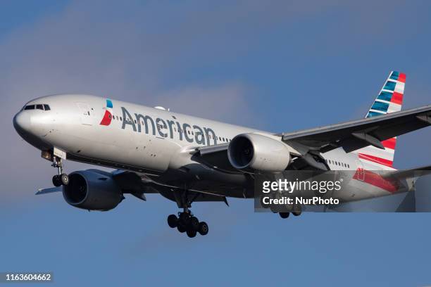 American Airlines Boeing 777-200 aircraft seen flying on final approach, while landing at London Heathrow International Airport LHR EGLL in England,...