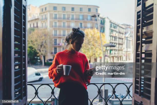 girl drinking coffee at the balcony in barcelona - women phone city facebook tourist stock pictures, royalty-free photos & images