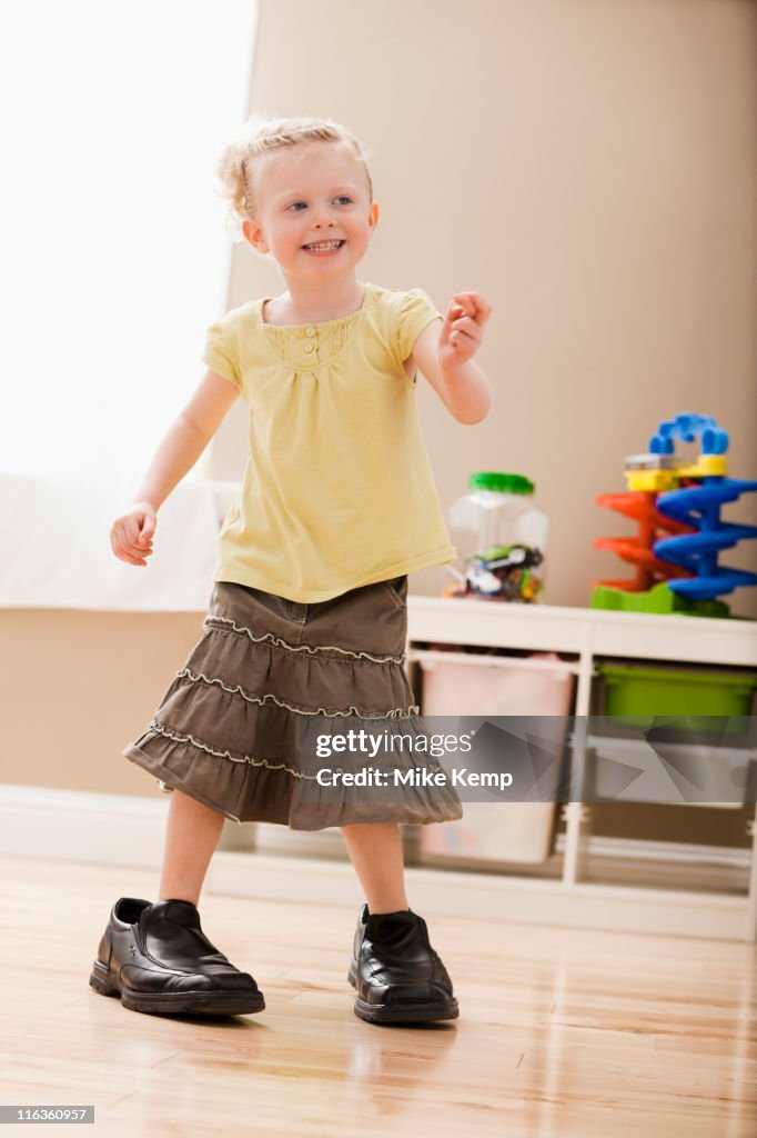 USA, Utah, Lehi, Girl (2-3) walking in dad's shoes