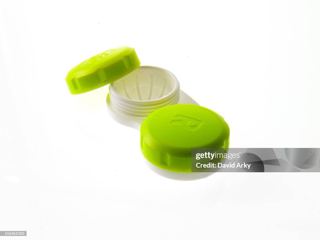 Green contact lens cases on white background