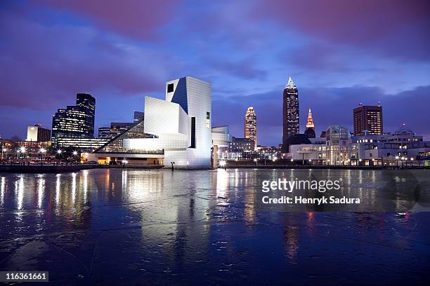 usa, ohio, rock and roll hall of fame and museum across frozen lake at dusk - cleveland ohio stock pictures, royalty-free photos & images