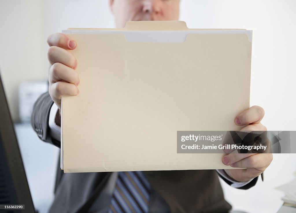 USA, Jersey City, New Jersey, businessman holding folder