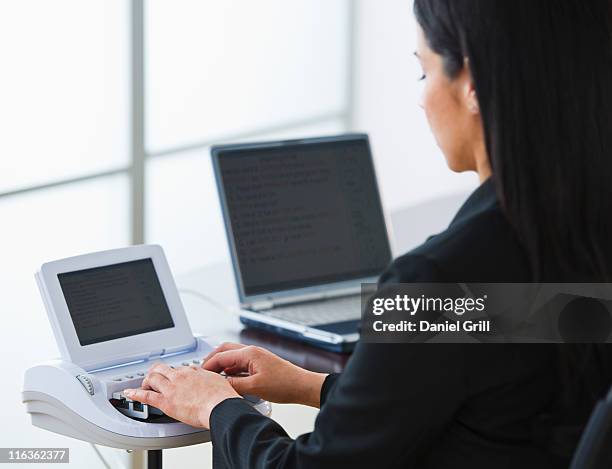 usa, jersey city, new jersey, court stenographer using stenograph machine - court reporter stock pictures, royalty-free photos & images