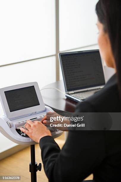 usa, jersey city, new jersey, court stenographer using stenograph machine - court reporter stock pictures, royalty-free photos & images