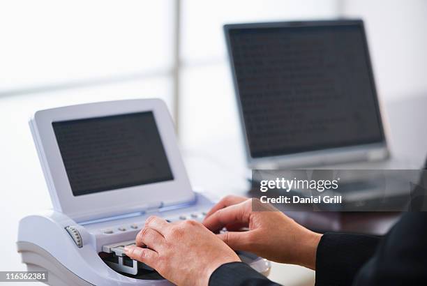 usa, jersey city, new jersey, court stenographer using stenograph machine - court reporter stock pictures, royalty-free photos & images