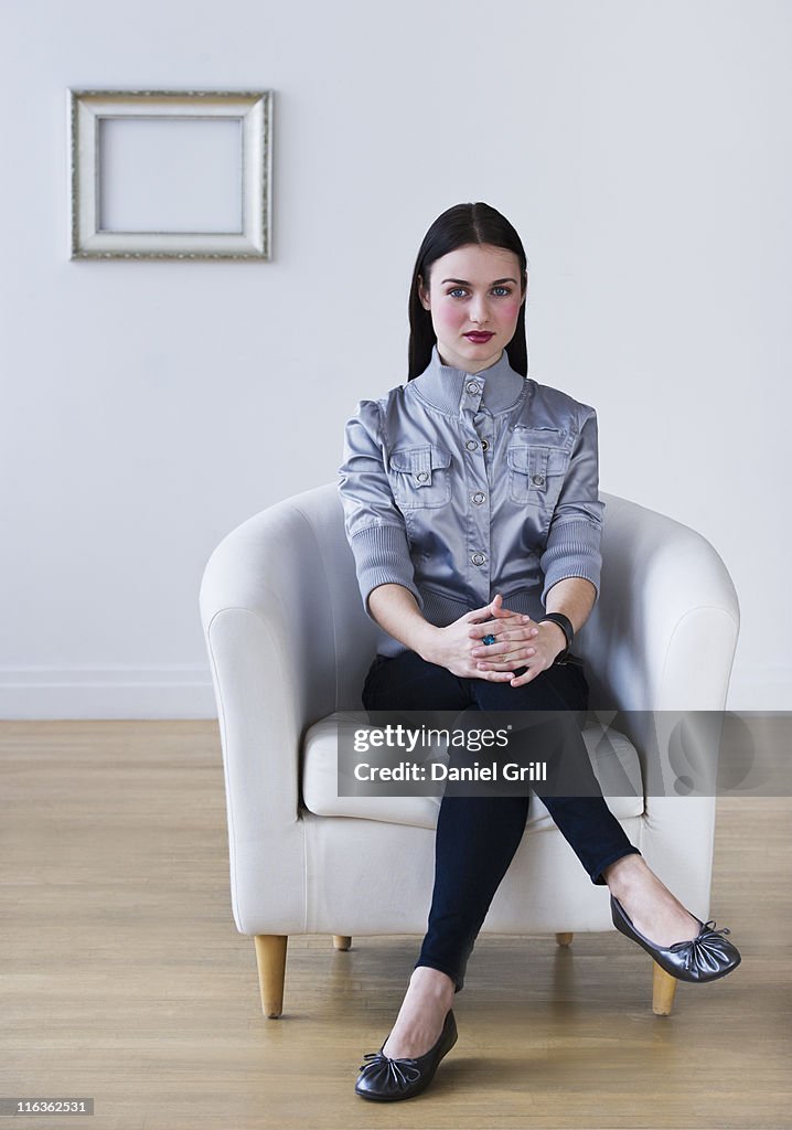 USA, Jersey City, New Jersey, portrait of woman sitting in armchair