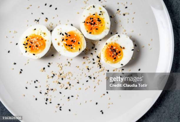 halved hard-boiled eggs on a plate - hard boiled eggs stock pictures, royalty-free photos & images