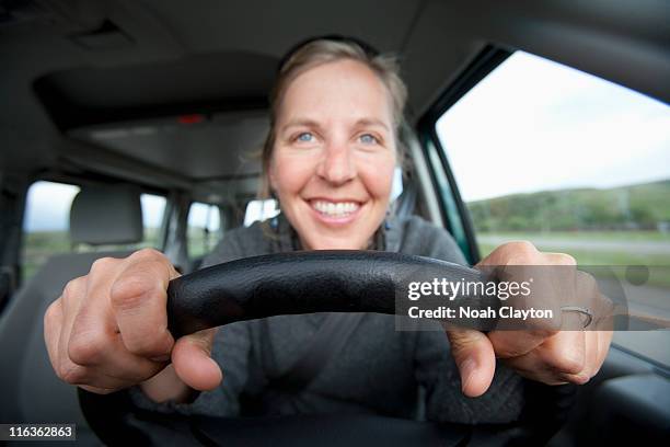 usa, california, mid adult woman driving - steering wheel stock-fotos und bilder