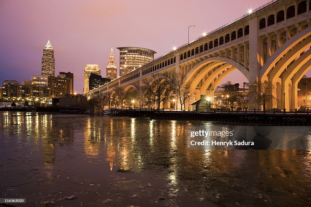 USA, Ohio, Cleveland, Bridge crossing Cuyahoga River at dusk