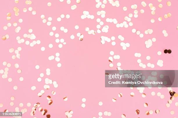 golden sparkles on pink pastel trendy background. festive backdrop for your projects. - women pastel stock-fotos und bilder
