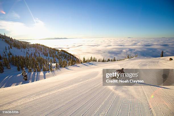 usa, montana, whitefish, male skier on mountain slope at sunrise - skipiste stockfoto's en -beelden