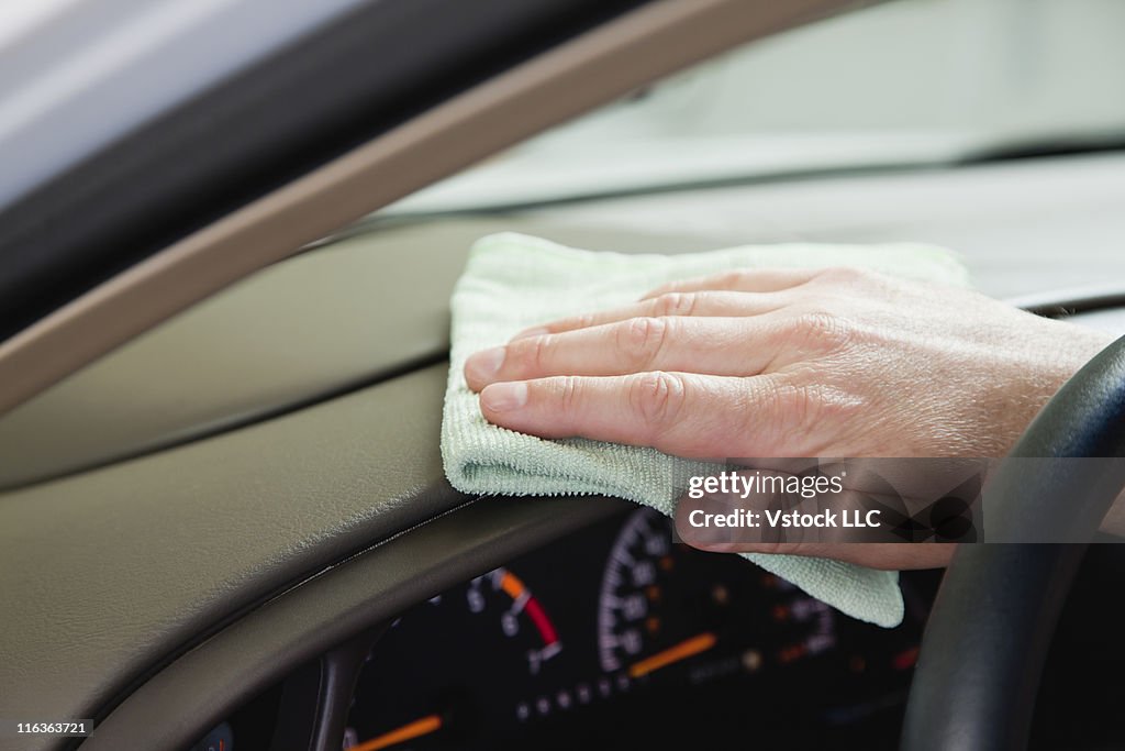 USA, Illinois, Metamora, Close up of man's hand cleaning car dashboard