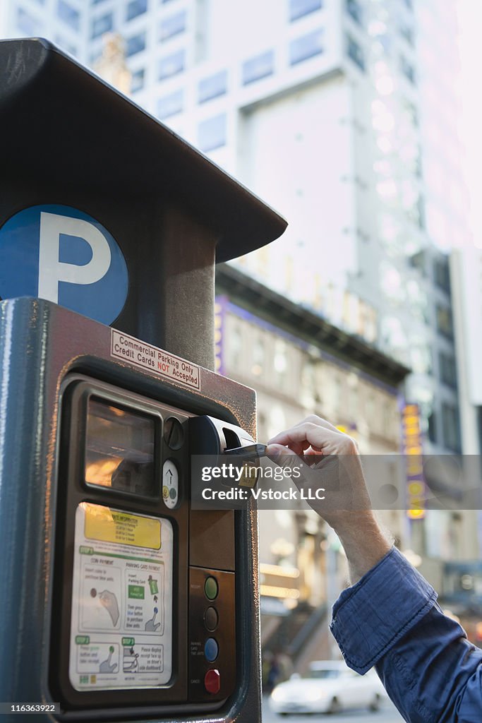 USA, New York, New York City, Man paying in parking machine